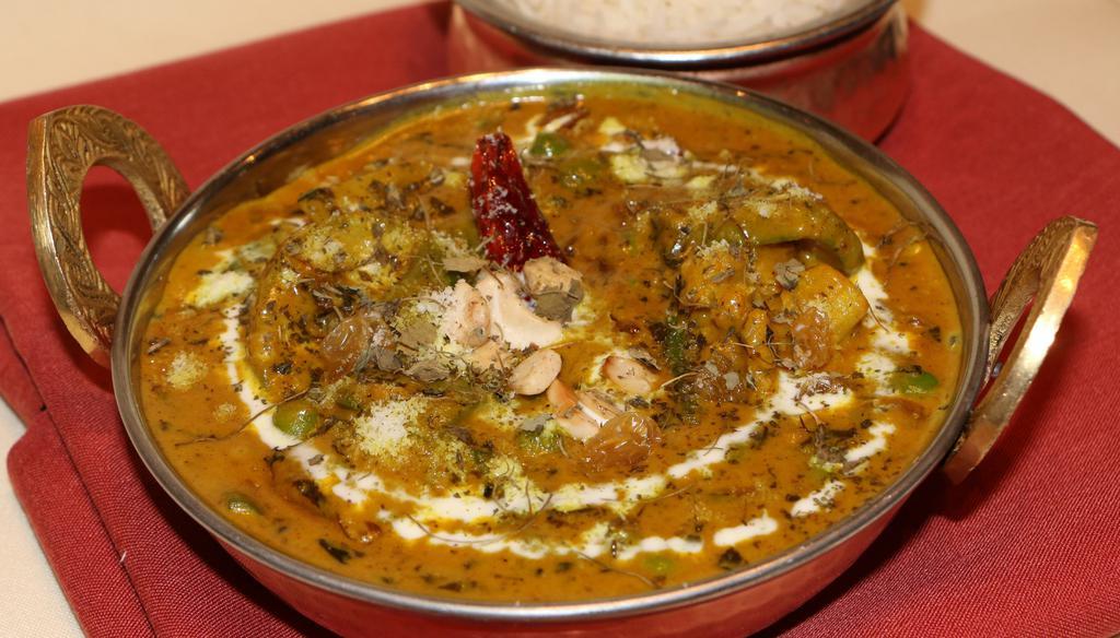 Navaratan Korma · Medley of vegetables cooked in light onion, cashew nut, and almond gravy