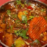 Kadai Sabzi · Vegan. Seasonal vegetables tossed with peppers, onions, tomatoes, crushed coriander.