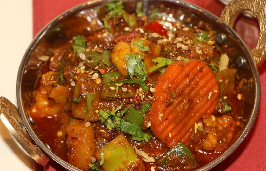 Kadai Sabzi · Vegan. Seasonal vegetables tossed with peppers, onions, tomatoes, crushed coriander.