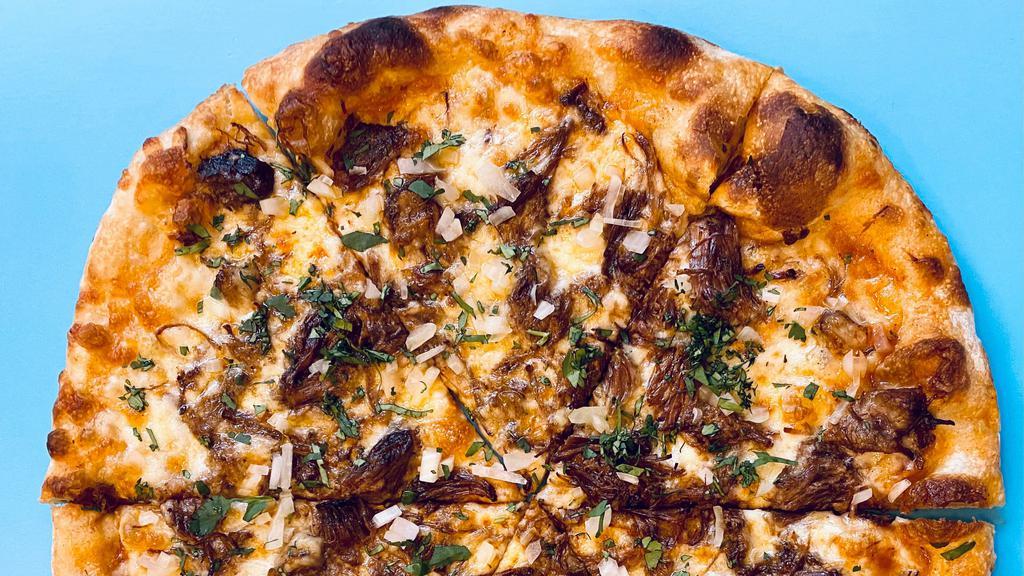 Birria Pizza · We are partnering with our friends at Tacqueria Nixtamal for this Cinco de Mayo Special. It comes with Birria, onion, Cilantro, and Birria Sauce