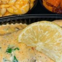 Salmon Soul Platter · (1) Sautéed Salmon Filet served over Seasoned Yellow Rice with a side of Candied Yams and Ba...
