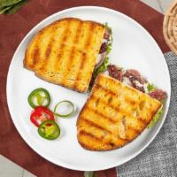 Russian Hill Panini · Roasted beef, Munster cheese, caramelized onions, lettuce, plum tomatoes, and Russian dressi...