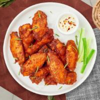 The Ranch Wings · Fresh chicken wings fried and tossed in classic ranch sauce. Served with your choice of dipp...