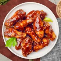 Bama Backyard Bbq Wings · Fresh chicken wings fried and tossed in classic BBQ sauce. Served with your choice of dippin...