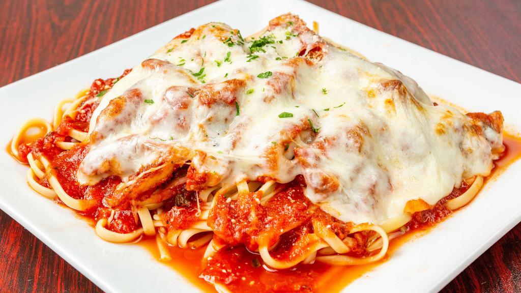 Chicken Parmigiana · Breaded chicken and homemade pasta tossed in marinara sauce and covered with cheese.
