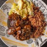 Savory Oxtails · Oxtail seasoned, pan braised and cooked until tender in a brown stew with butter beans and c...