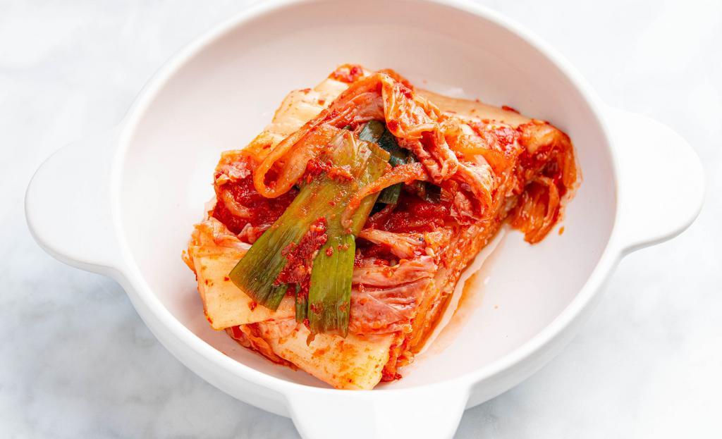 Korean Cabbage Kimchi · 32oz. the most basic type of kimchi made of half korean cabbages. the cabbages are cut in half and then salted or soaked in salt water. after the leaves have lost some of their water a mixture of sliced white radish garlic red chili pepper powder green onions fish sauce and ginger is spread over the layers of leaves.