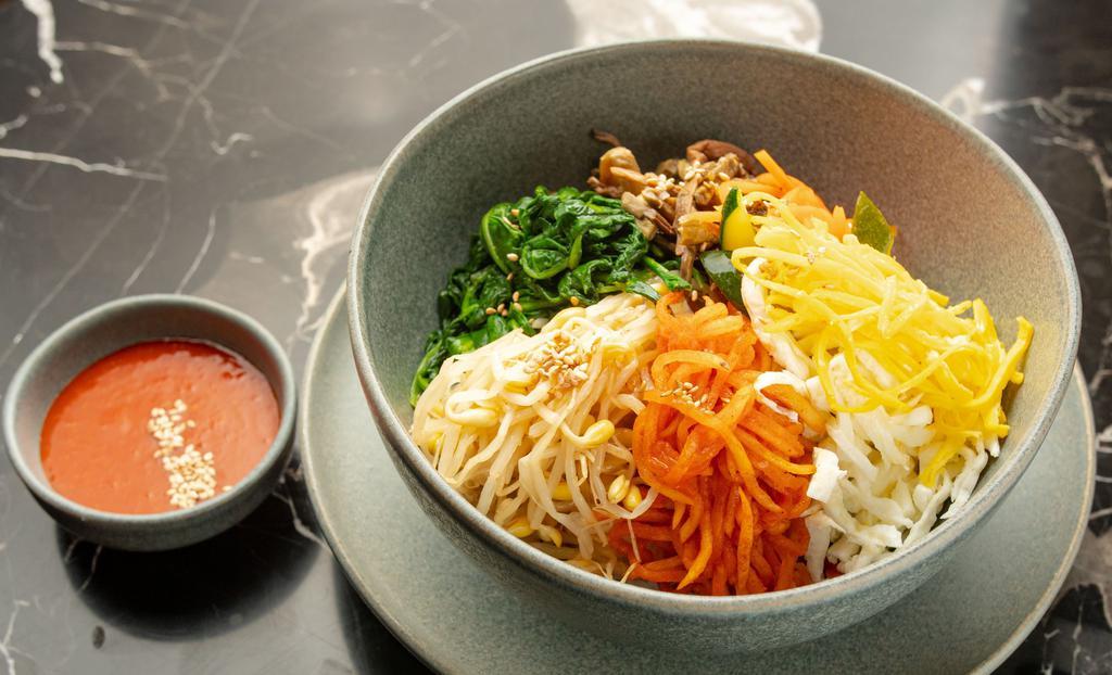 World Best Bibimbap · Sauteed and seasoned vegetables over rice served with fried egg and OHHO spicy sauce. Add bulgogi, spicy pork, chicken, tofu, or fried kimchi for an additional charge.