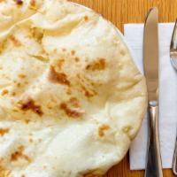 Plain Or Butter Naan · Soft and puffy leavened bread freshly baked in tandoor.