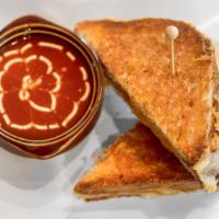 Grilled Cheese & Tomato Soup · Homemade sour dough bread and melted gruyere-cheddar cheese.