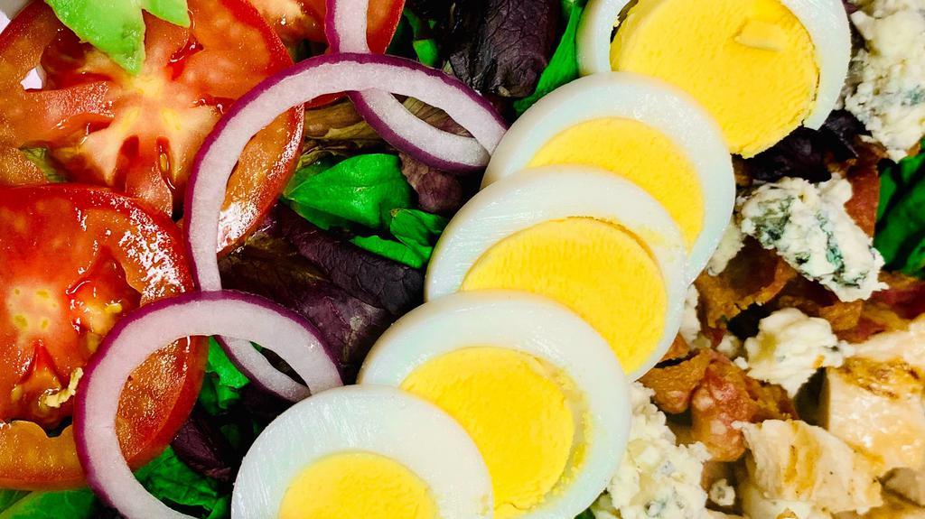 Cobb Salad · Mixed greens, bacon, avocado, blue cheese, red onions, tomatoes, hard boiled eggs, blue cheese dressing plus grilled chicken.