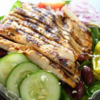 Greek Salad · Crisp Lettuce, Fete Cheese, Stuffed Grape Leaves, Tomato, Olives & Onions.