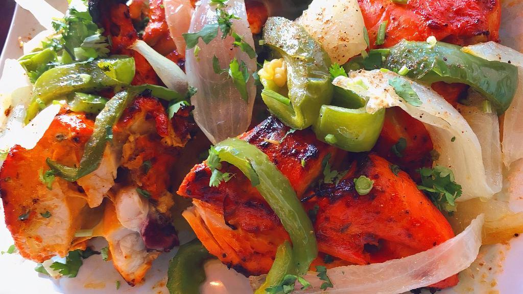 Tandoor Murgh · Bone in chicken grilled and red marinade. Comes with rice.