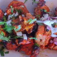 Murgh Tikka · Skewered chicken thighs and lemon. Comes with rice.