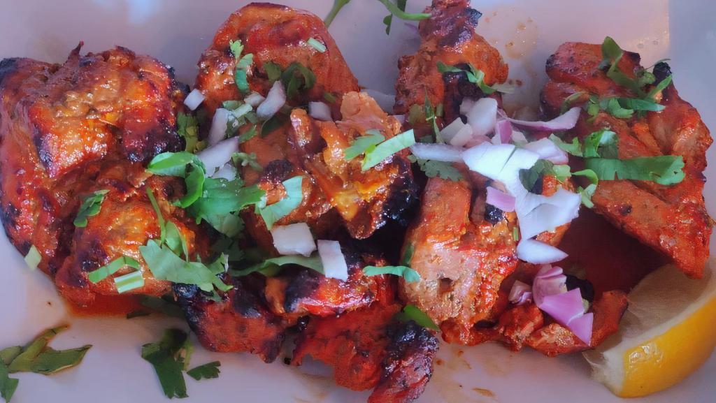 Murgh Tikka · Skewered chicken thighs and lemon. Comes with rice.