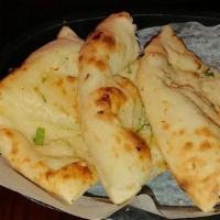 Garlic Naan · Tandoor fired white flour bread.