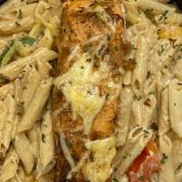 Salmon Casa Pasta · Salmon chargrilled  to perfection in a creamy alfredo sauce with penne pasta, red, yellow an...