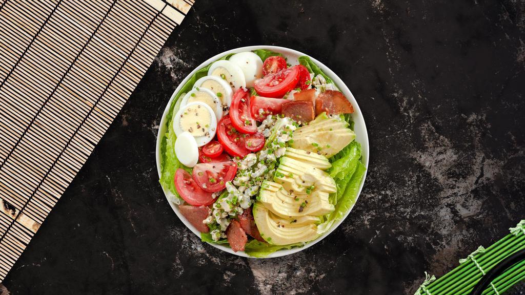 Cobb County Salad · (Vegetarian) Romaine hearts, sliced lean chicken breast, shredded carrots, sliced mushrooms,  blue cheese, bacon, hard-boiled pastured egg, avocado, and tomato tossed with vinaigrette dressing.