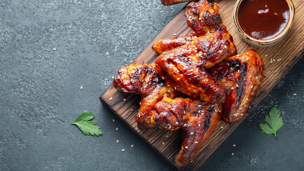 Bbq Chicken Wings · Chicken wings deep fried to perfection and smothered in BBQ sauce. Served with celery, carrots, and dipping sauce.