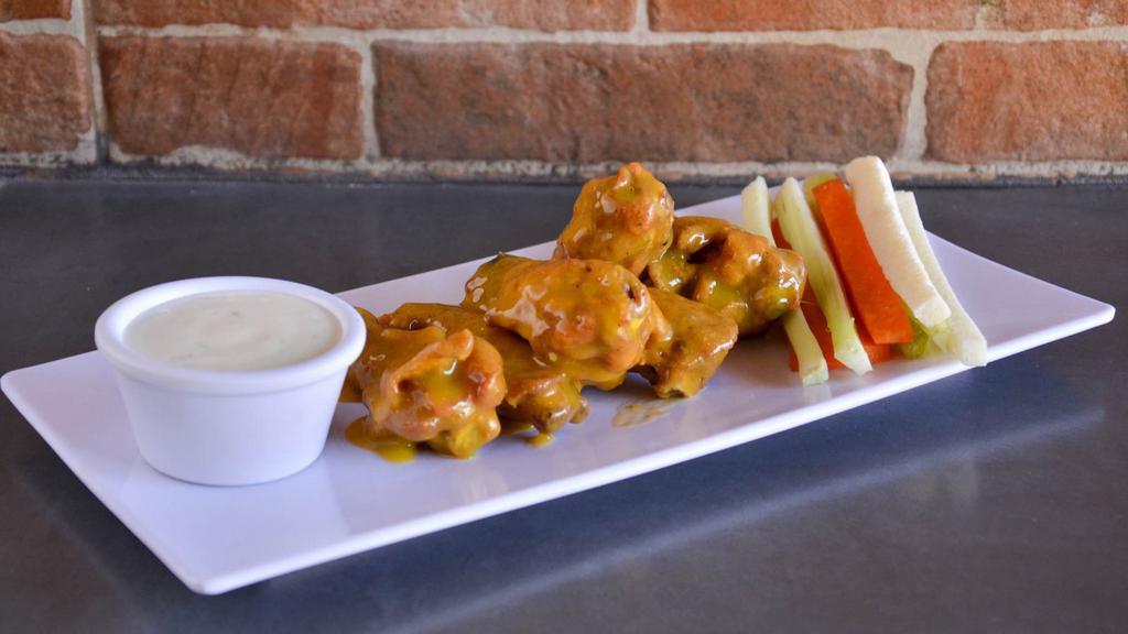 Mango Habanero Chicken Wings · Chicken wings deep fried to perfection and smothered in mango habanero sauce. Served with celery, carrots, and dipping sauce.