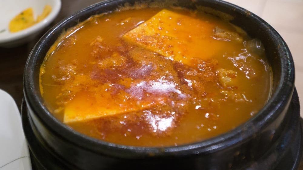 Kimchi Tofu Stew · Hot. Spicy soft tofu stew with vegetables, kimchi, pork and egg. Served with rice and kimchi.
