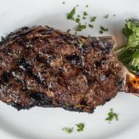 Cowboy Garlic Rib Steak · USDA prime aged 24 oz. bone in rib steak rubbed with a seasoned mixture of fresh garlic, gro...