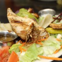 Wood Grilled Chicken Souvlaki · With Peppers,Onions, Tomatoes. Served with a Greek Salad, Pita and Tzatziki.