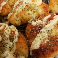 Garlic Knots · Fluffy buttery knots-shaped dough, baked and topped with chopped fresh garlic, olive oil and...