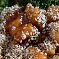 Sesame Chicken · Deep fried battered chicken tossed in sweet sesame sauce. Served with chicken fried rice wit...