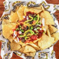 Garbage Nachos · Nachos Topped with Chili, Cheese, Onions, Peppers, Tomatoes, Jalapenos, Olives, and Serve wi...