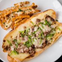 Steak Sandwich · Sliced steak and caramelized onions topped with swiss and pepper jack cheese served with par...