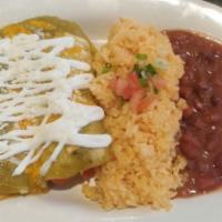 Enchilada · Choice of protein, choice of sauce, sour cream, cotija cheese, rice and beans.