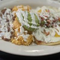 Huevos Rancheros · Sunny side up eggs over two tortillas. Served w/ salsa roja, pico de gallo, avocado, sour cr...