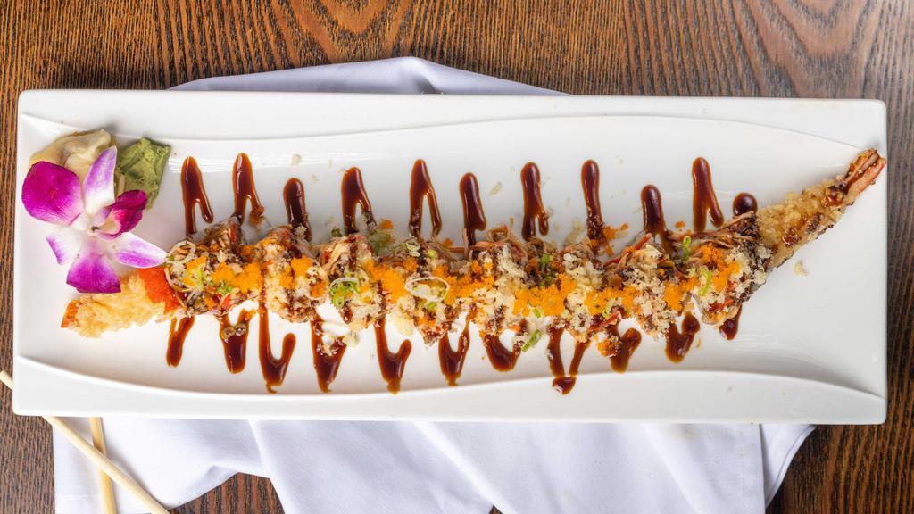 Angry Dragon Roll · Shrimp tempura, spicy tuna inside, topped with spicy crab and eel sauce, and chili sauce.