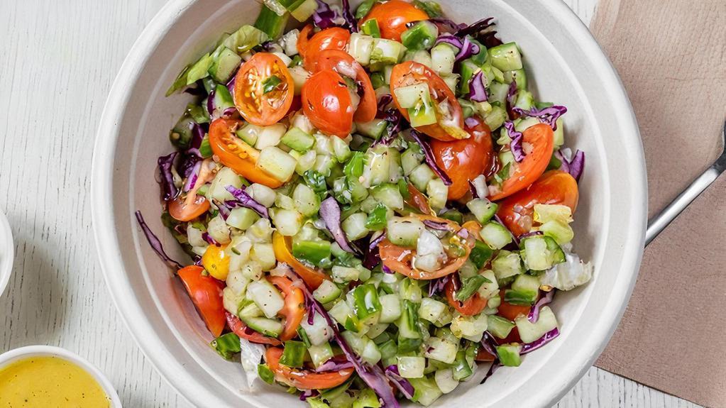 Israeli (Chopped) Salad · (Vegan) Romaine, cucumber, tomato, parsley, scoop of tahini and lemon mustard dressing.