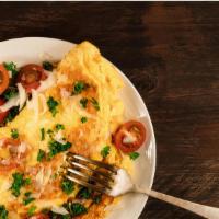 Veggie Omelettes · Fluffy, three egg omelette with sautéed onions, peppers, broccoli, mushrooms, tomatoes and m...