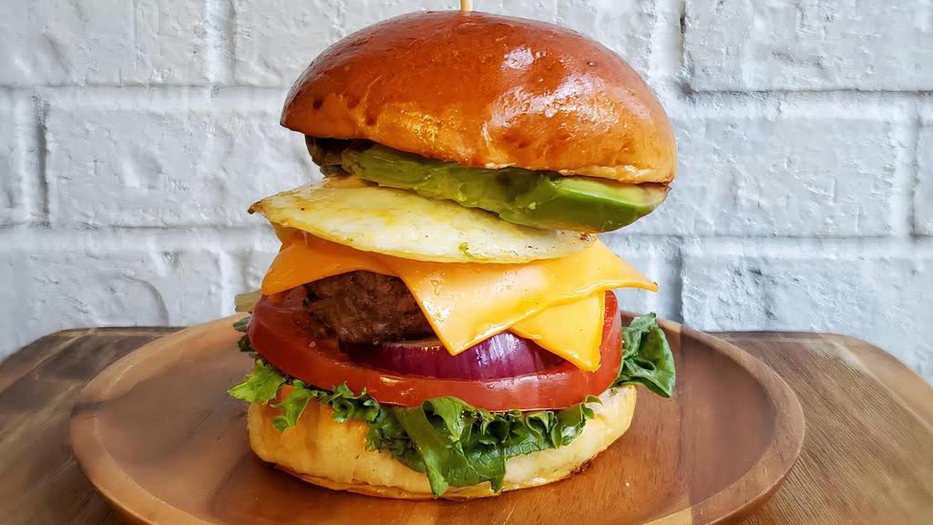 Signature Weekender · Farm-raised, hormone free, quarter-pound beef patty. Served on brioche with lettuce, tomato, red onion, avocado, American cheese, and fried egg