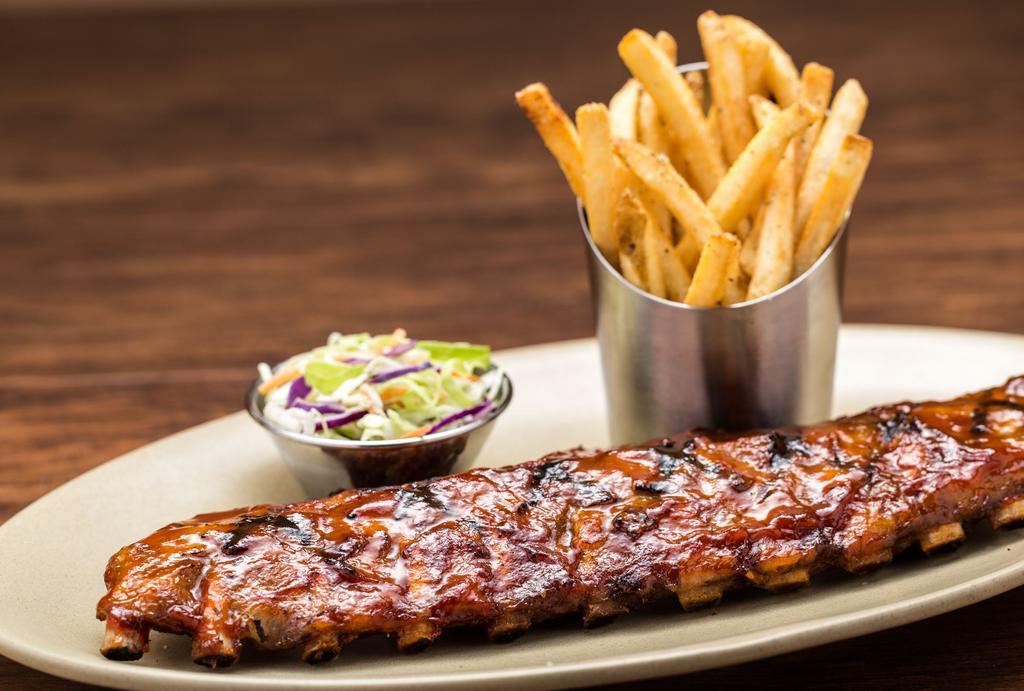 Bbq Grilled Baby Back Ribs · Baby back ribs is basted with BBQ sauce and served with French fries and coleslaw .