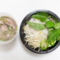 Pho Bo (Beef) · Rice noodle soup served with sliced beef, beef brisket, and meatballs.