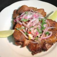Chuleta Frita Combo · Fried pork chops. Served with rice, bean, and salad or french fries and salad or yellow plan...