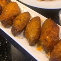 Chicken Wings · Deep-fried chicken wings available in plain, spicy buffalo, lemon pepper or garlic.