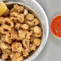 Fried Calamari · Served with tomato sauce and lemon wedges on the side.
