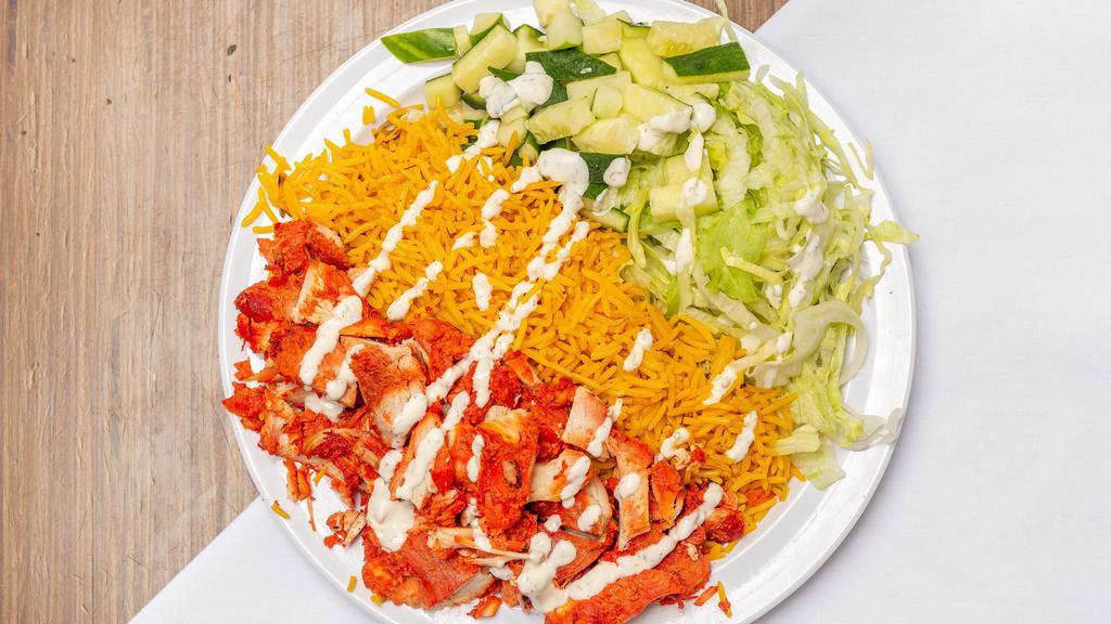 Chicken Over Rice & Salad · Halal chicken cooked with onions and peppers over rice and salad. Topped with choices of sauces.