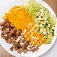Lamb Over Rice & Salad · Halal lamb cooked with onions and peppers over rice and salad. Topped with choices of sauces.