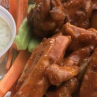 Breaded Wings · 8 piece wing order. With the choice of BBQ, Mild, Or Hot. Served with Blue Cheese, celery & ...