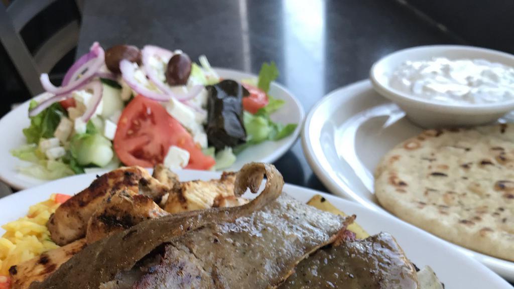 Gyro Dinner Platter · Thinly sliced Rotisserie Lamb & Beef.  Served with  warm pita bread on the side. Served with salad or soup. Served with 2 sides.
