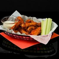 Chicken Wings · Crispy fried chicken wings tossed in your choice of sauce. Served with celery and ranch or b...