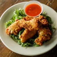 Homemade Chicken Wings · Served with hot sauce, fresh herbs, garlic and oil.