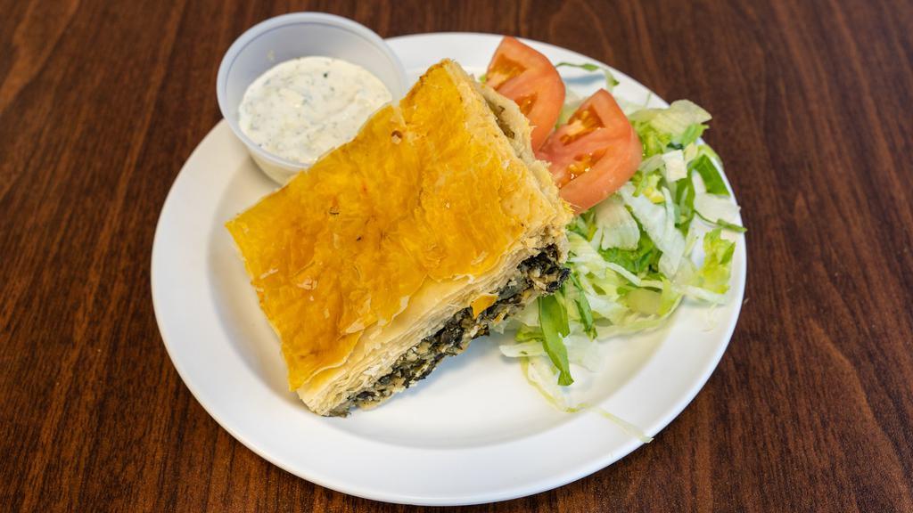 Spinach Pie (Spanakopita) · Spinach, feta cheese, herbs and spices wrapped in filo dough.