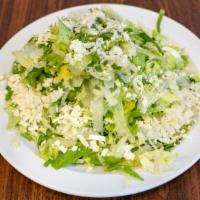 The Village Salad · Romaine lettuce, scallions, dill, and feta cheese tossed in our special house lemon dressing.